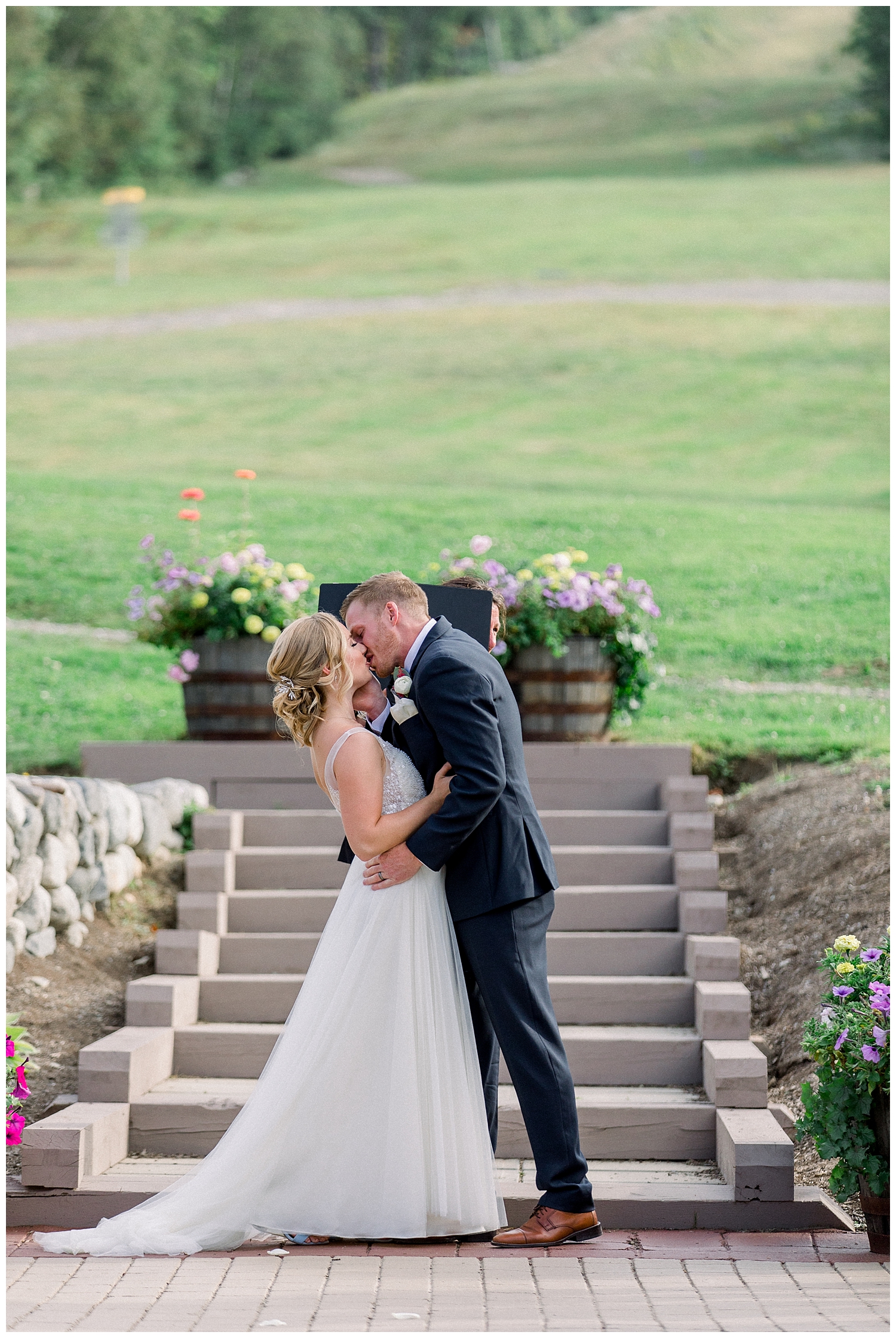 First kiss at outside wedding ceremony at Sugarloaf Mountain Resort in Maine, photos by Halie Olszowy.