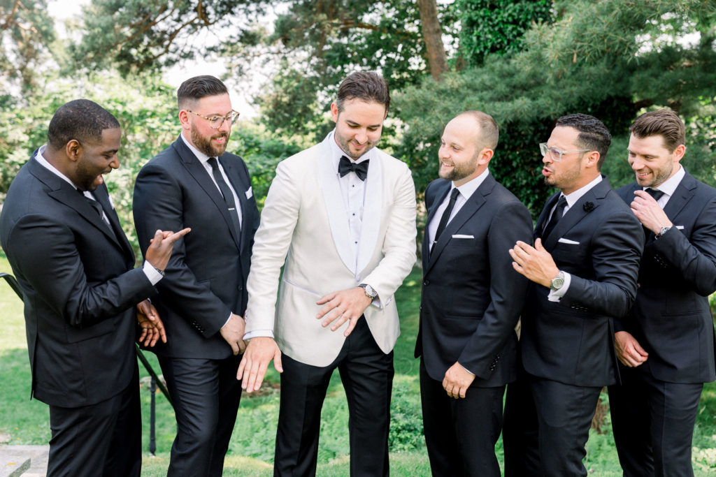 Indochino groom and groomsmen at Wentworth by the Sea NH wedding, white tux