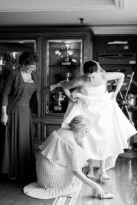 Stamford Yacht Club Wedding - CT Wedding, bride getting into classic BHLDN strapless wedding dress