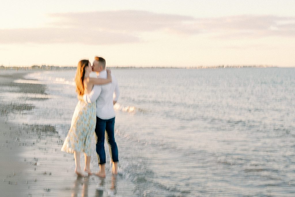 Couple kissing on a beach in Duxbury, MA