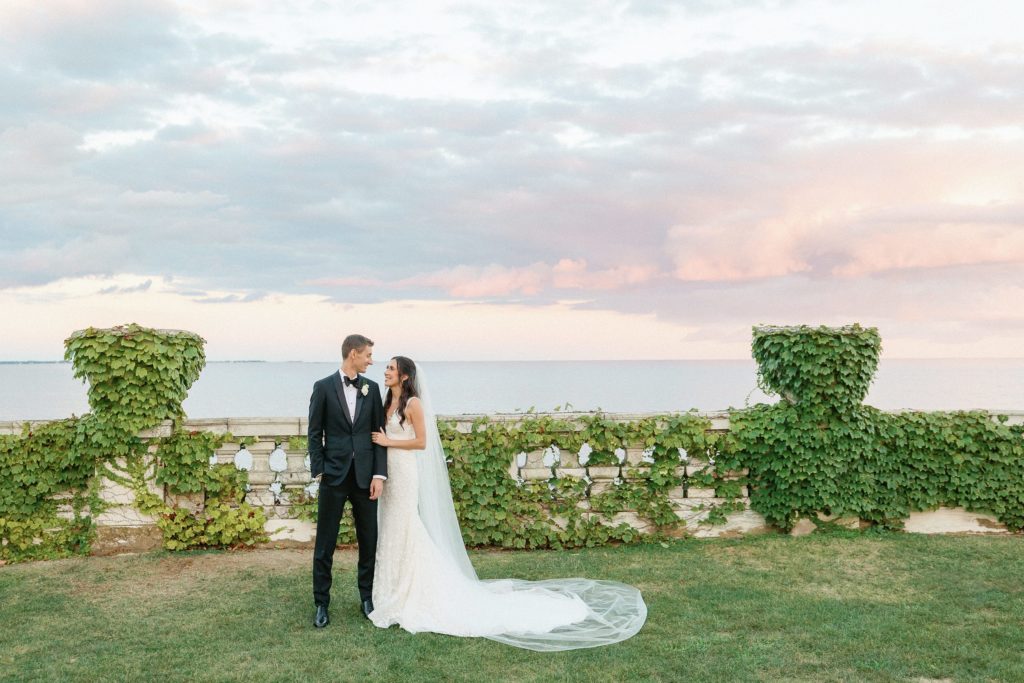 Bride and groom sunset portrait at Rosecliff Newport Mansion 