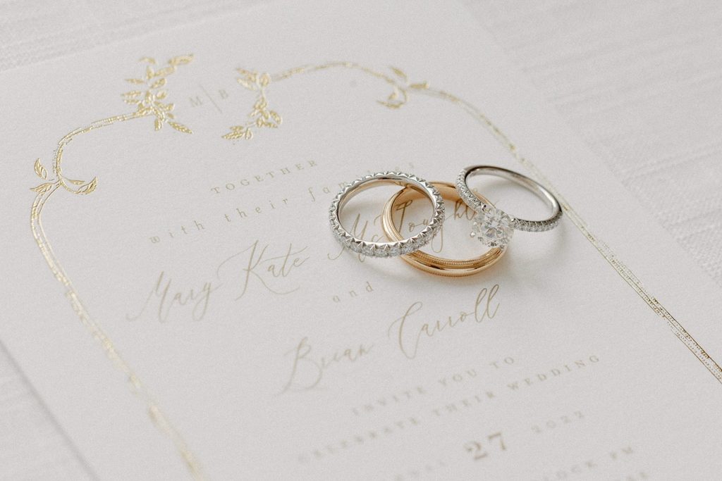 Wedding ring and engagement flatlay on invitation suite for Portsmouth, RI wedding