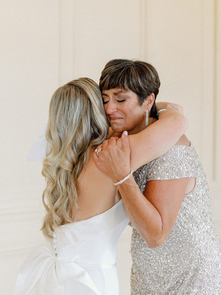 Bride hugging her mom on wedding day 