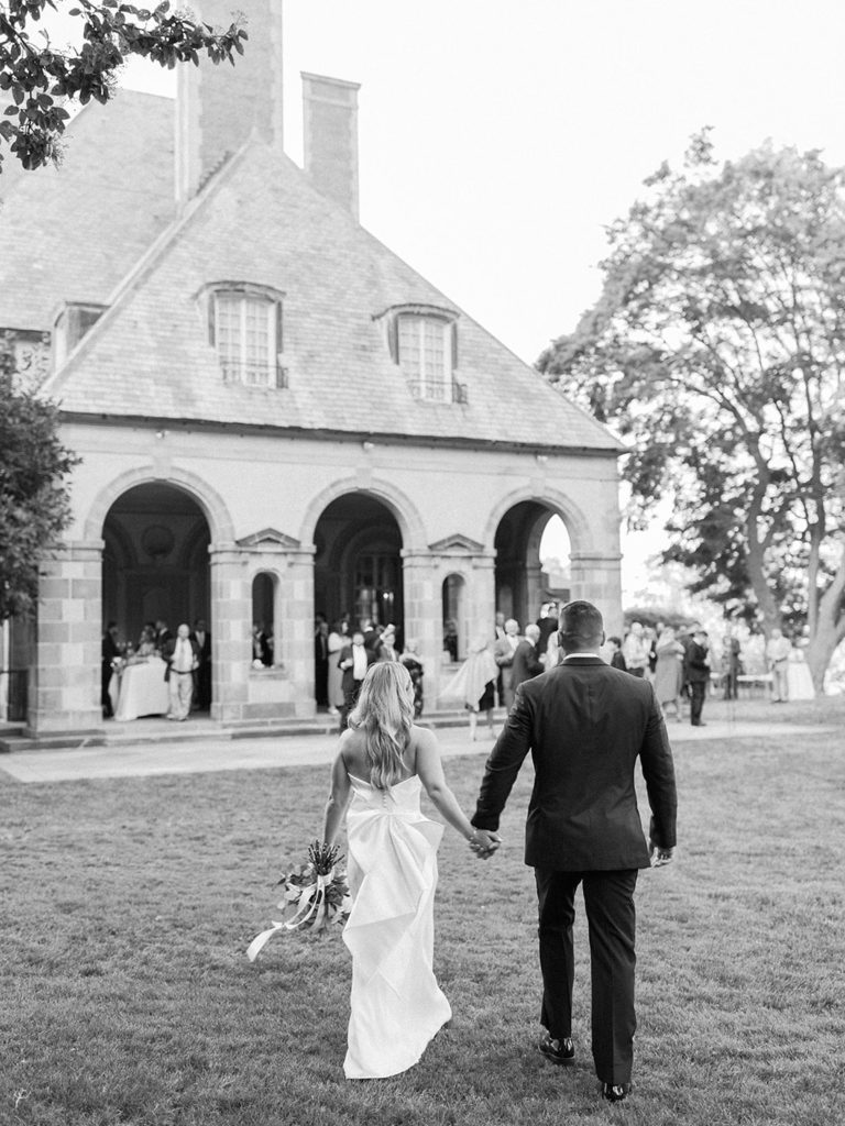 Bride and groom walking into cocktail hour at Glen Manor House in Portsmouth, RI