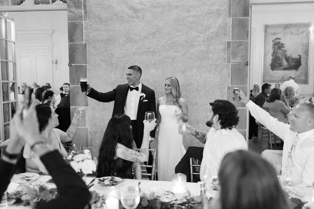 Bride and groom toast during wedding reception 