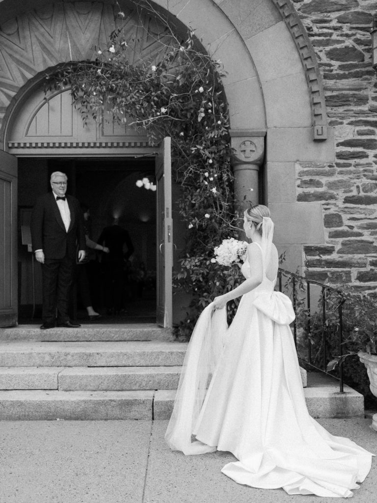 Bride walking into Our Lady of the Snows Church in Woodstock, VT