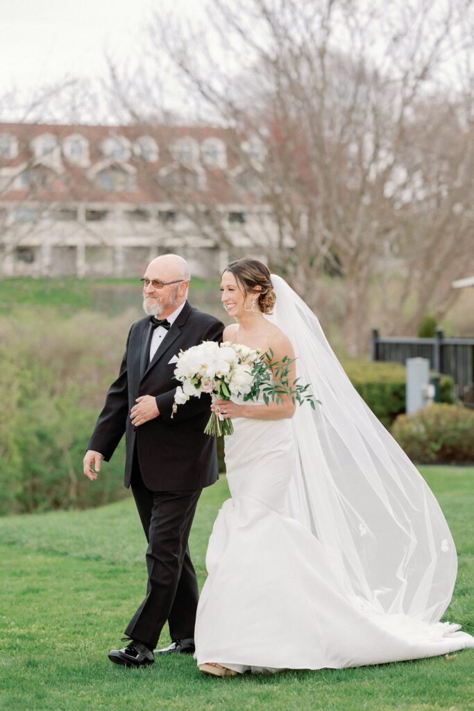 Bride walking down the aisle with her dad for Newport wedding 