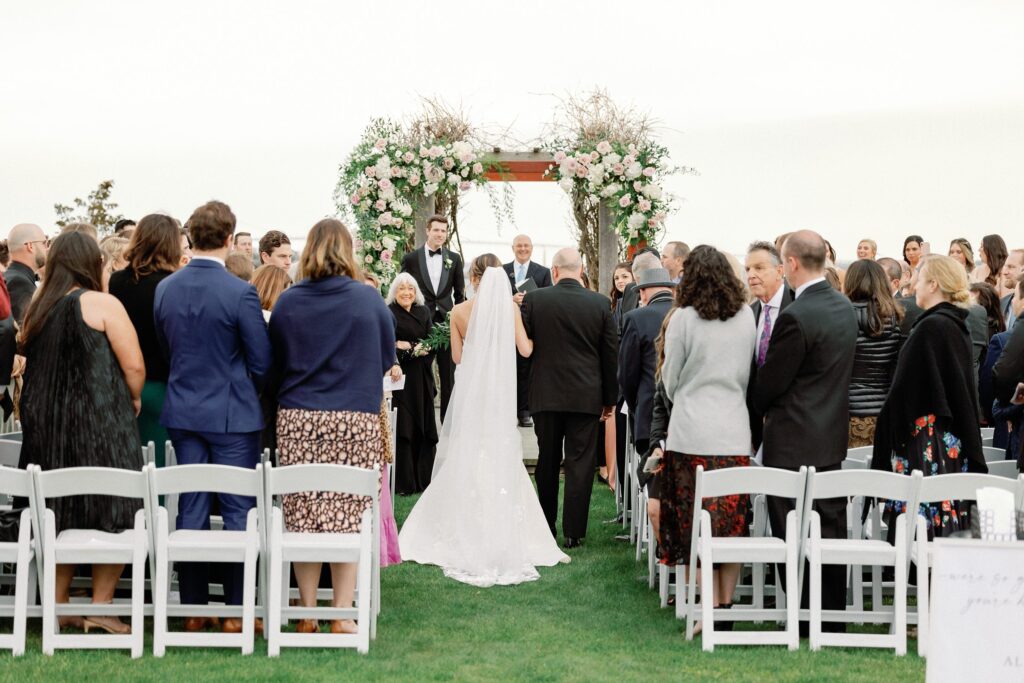 Outdoor ceremony under chuppah with ocean view for Newport wedding