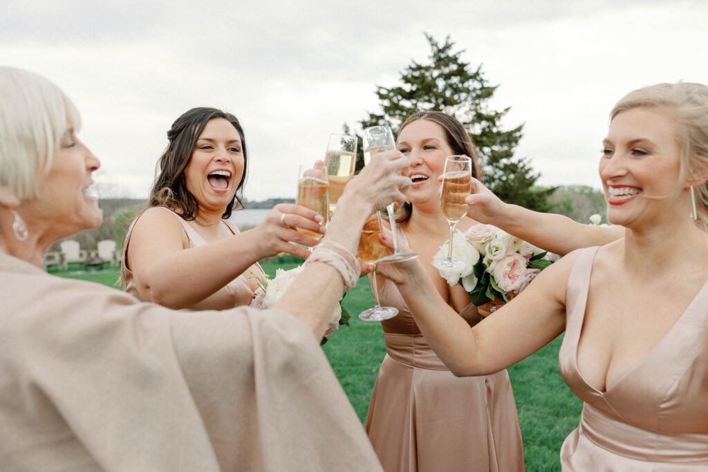 Bridal party post ceremony doing a cheers 