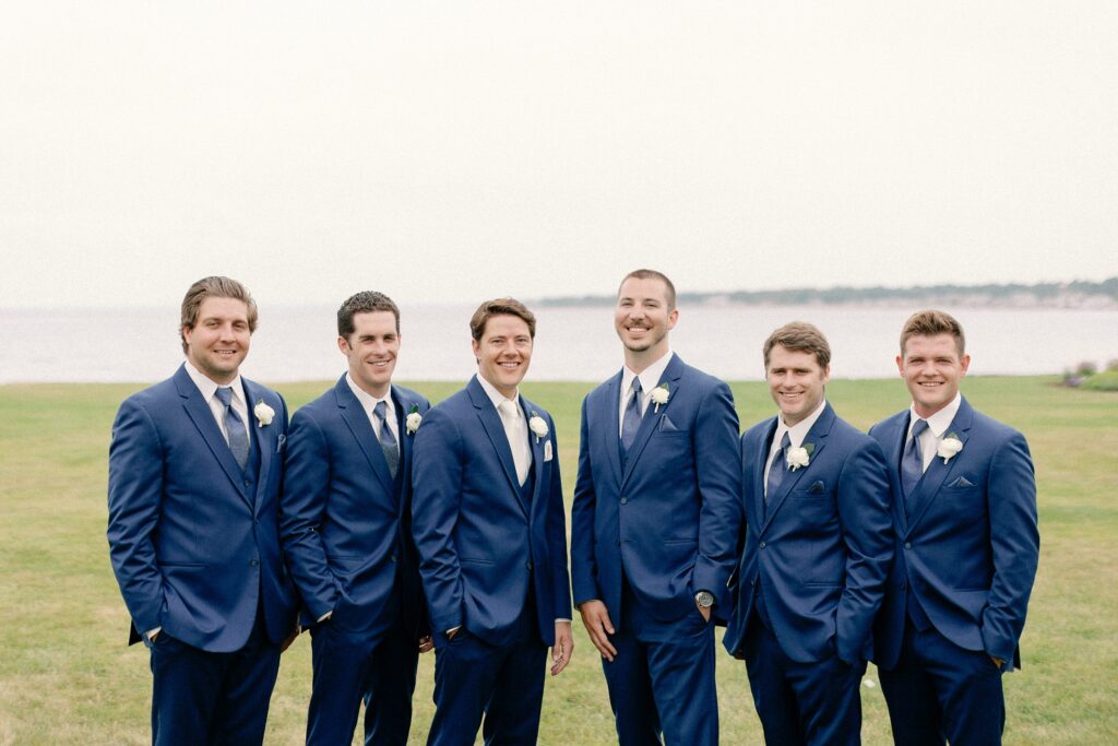 Groom and groomsmen portraits for summer wedding on the coast of New Hampshire