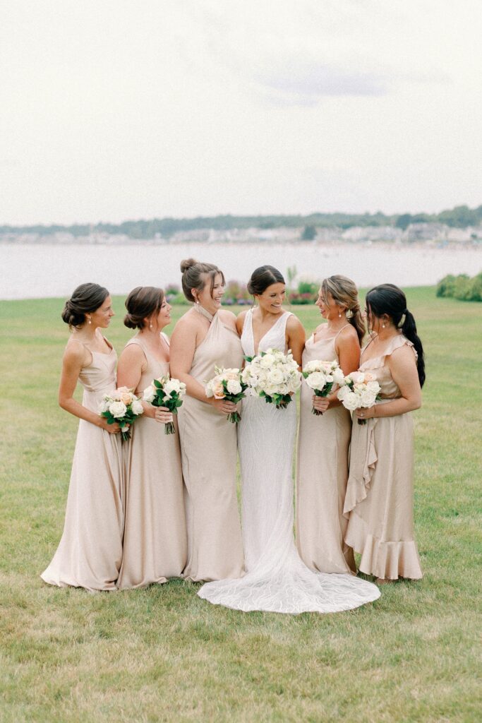 Bride and bridesmaids wedding day portraits on the coast of New Hampshire with champagne colored dresses
