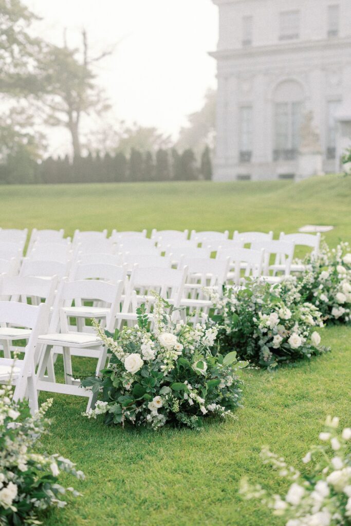 Rosecliff outdoor ceremony floral design along the aisle with ocean views 