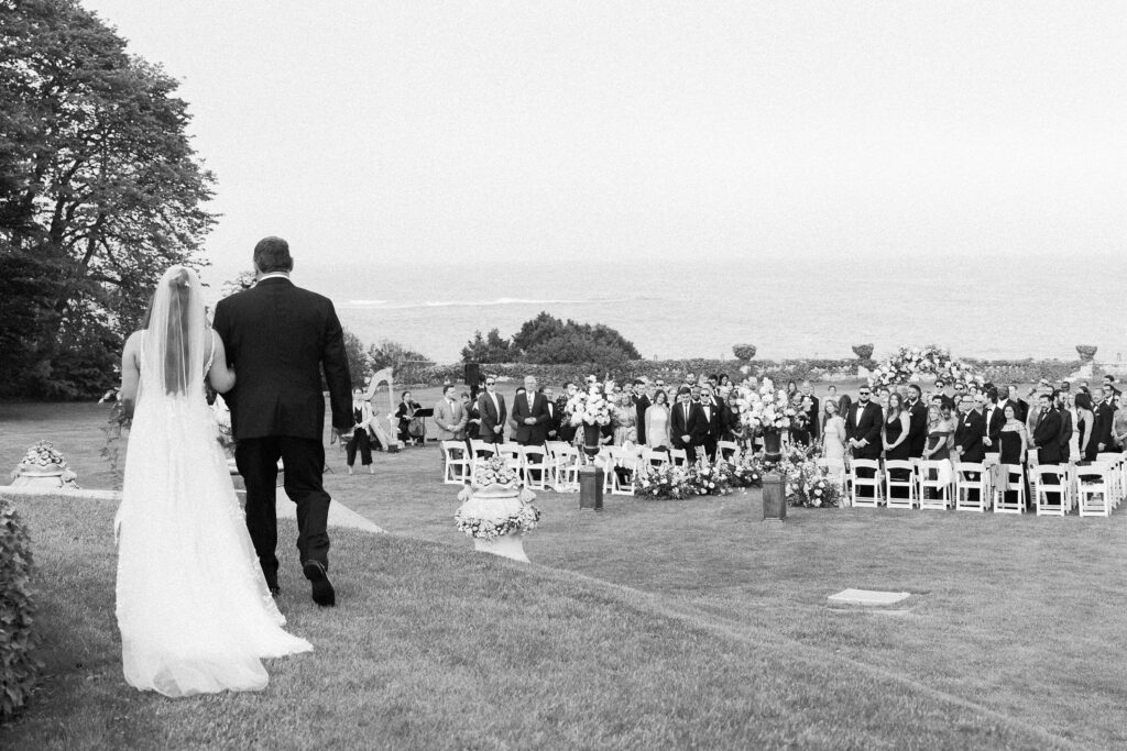 Bride walking down the aisle with her father at Rosecliff Mansion in Newport