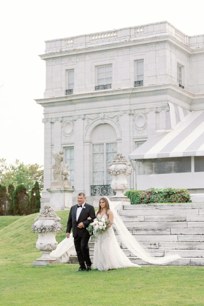 Bride walking down the aisle with her father at Rosecliff Mansion in Newport