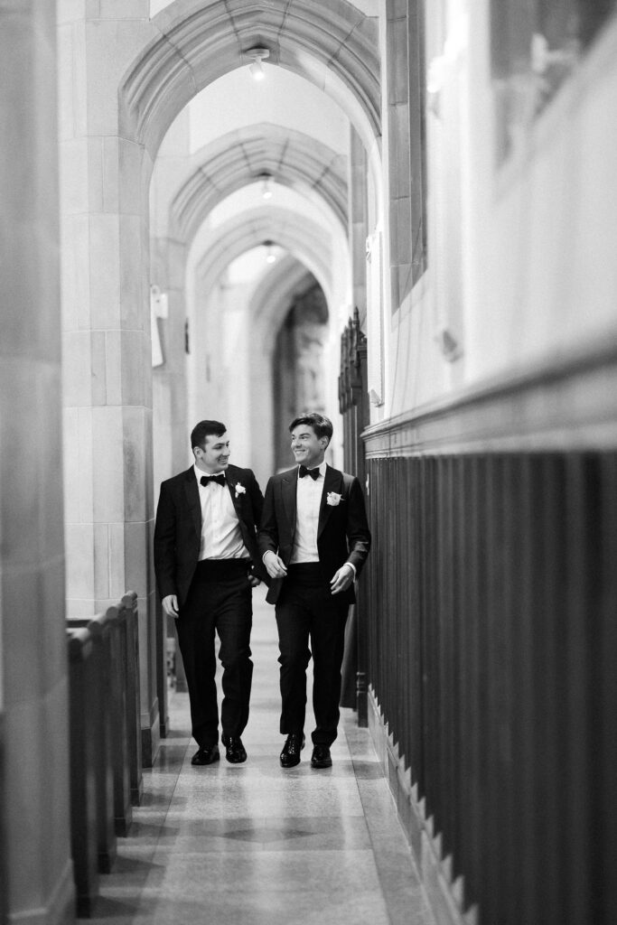 Candid black and white photo of the groom at Saint Ignatius in Boston