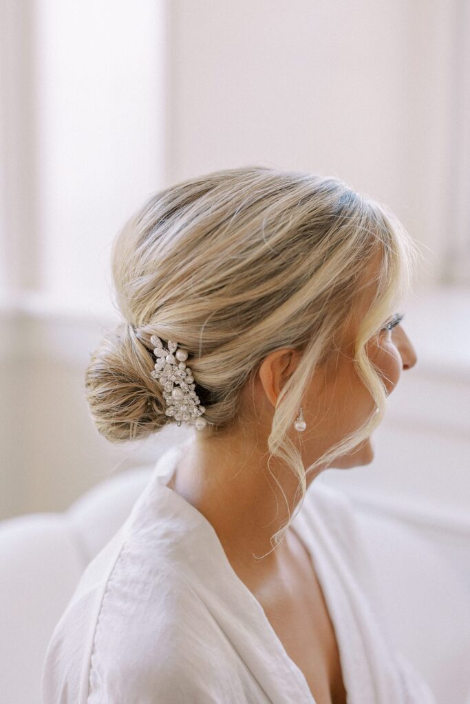 Bridal updo with loose curls and pearl hair clip for Boston wedding