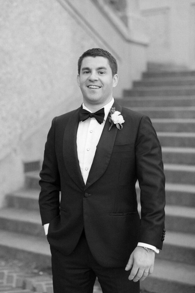 Groom black and white portrait in the steps of Crane Estate