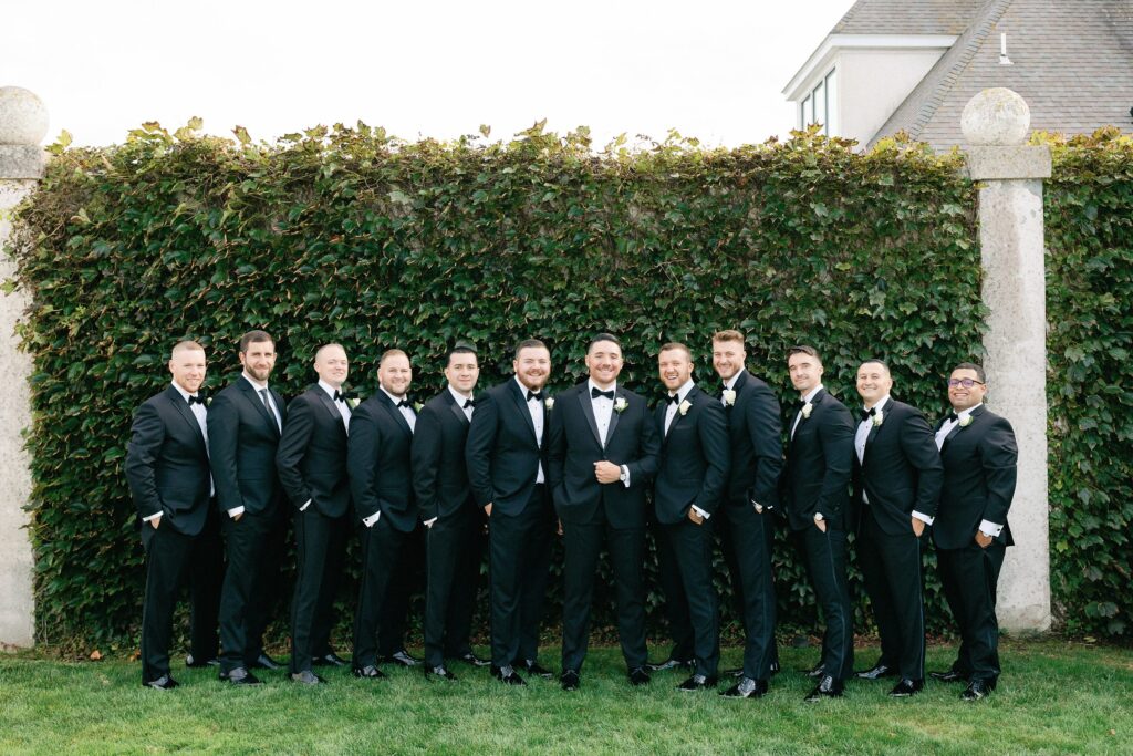 Groom and groomsmen portrait in tuxedos and bow ties for Newport wedding