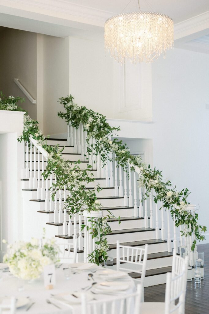 Ivy and baby's breath decorated stairs at Belle Mer wedding reception