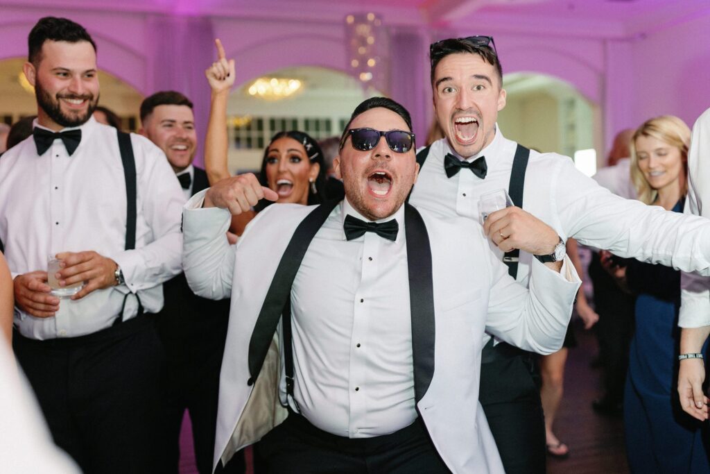 Groom and groomsmen on dance floor at wedding reception