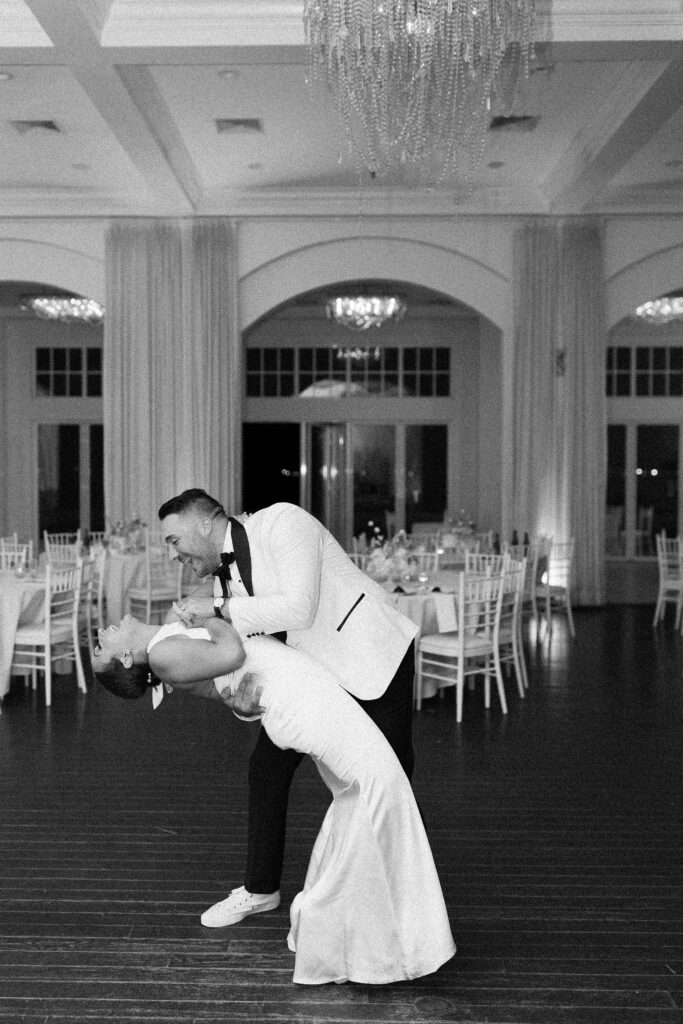 Black and white grainy photo of bride and groom last dance during Belle Mer wedding reception in Newport, RI