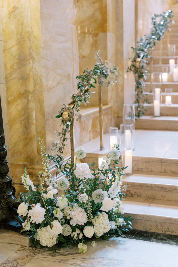Floral arrangements and candles on the stairs of the Boston Public Library
