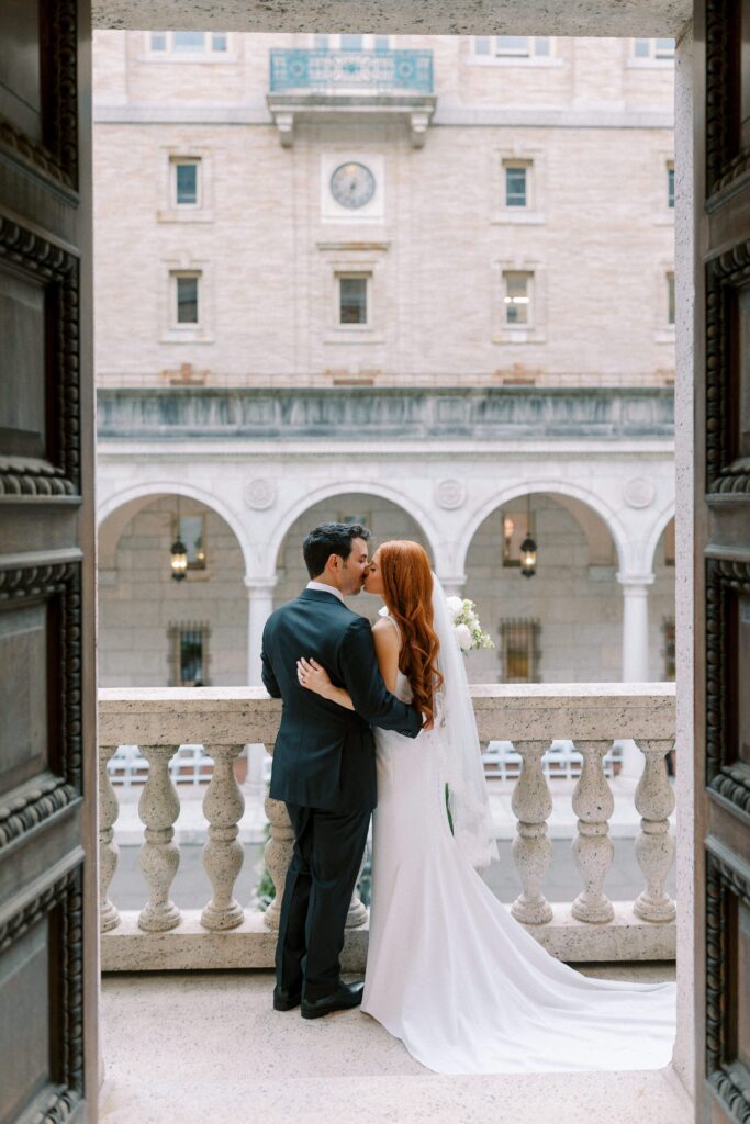 Bride and groom portrait on the iconic stairs balcony overlooking the courtyard 