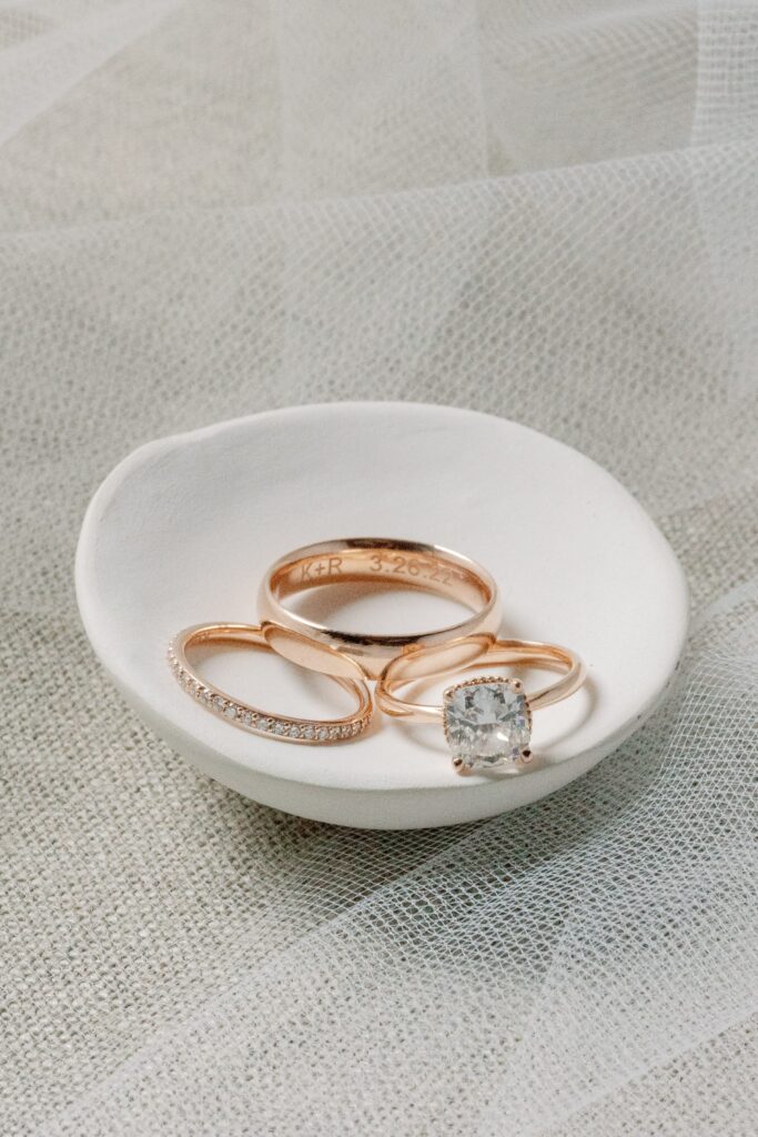 Engraved wedding band and engagement ring photography