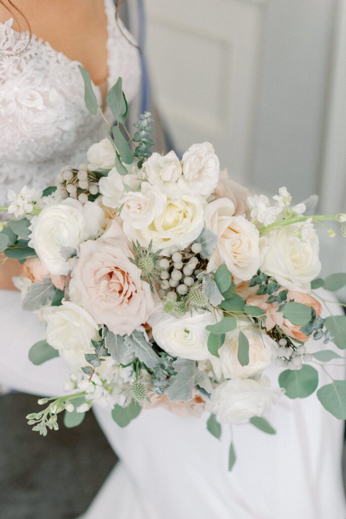 Gorgeous winter bridal bouquet with white roses and touches of pink 