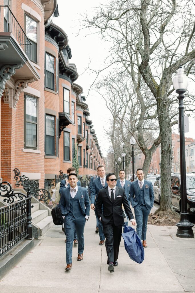 Groom and groomsmen walking on the streets in Boston during portraits 
