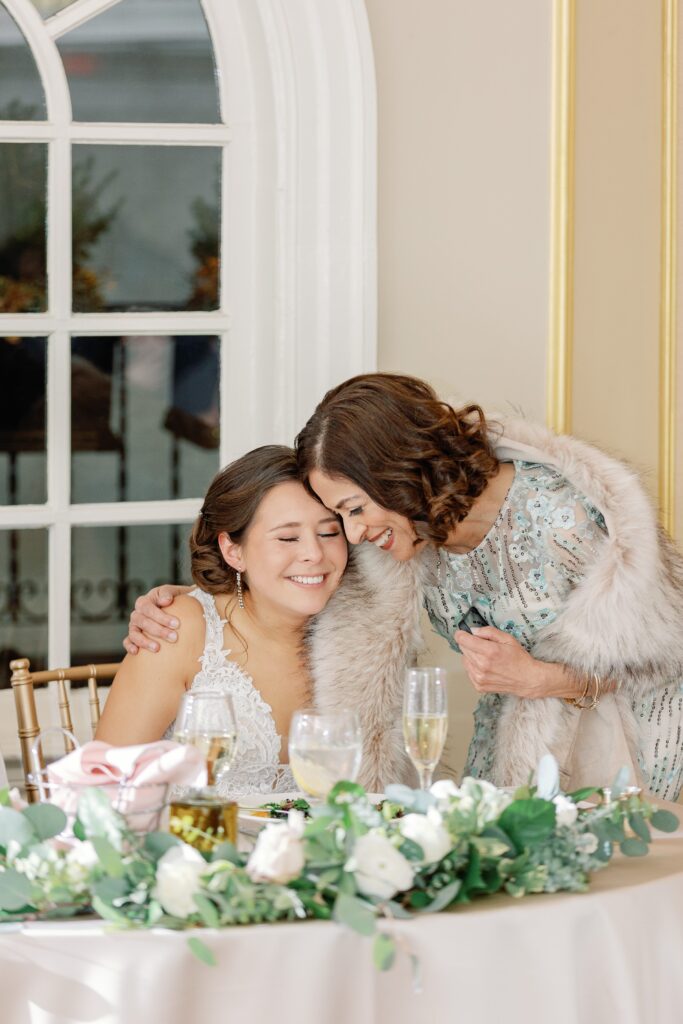 Bride hugging her mom during wedding reception at The Lenox Hotel