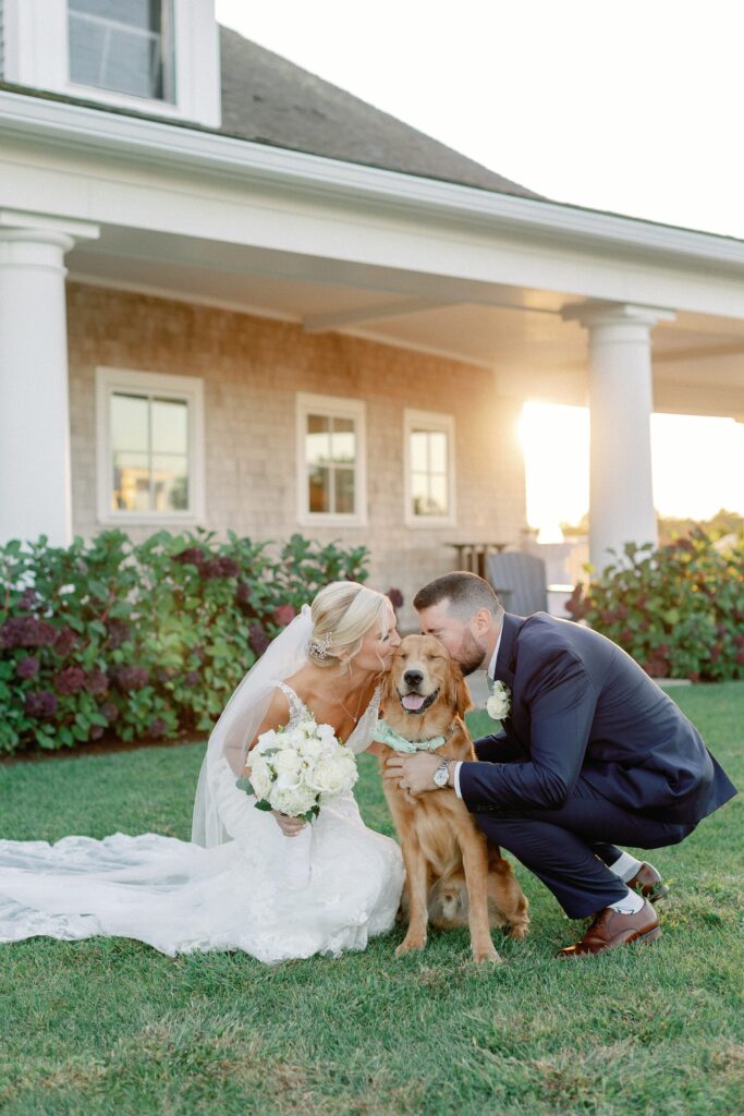 Bride and groom portrait with their golden retriever on wedding day 