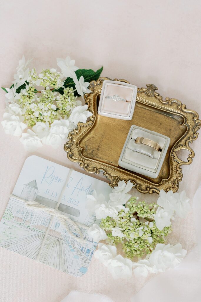 Wedding flat lay details with rings and invitations for Cape Cod wedding