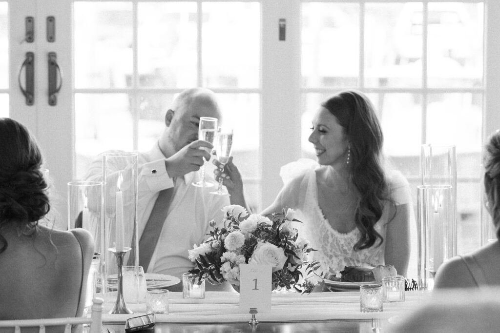 Bride and groom cheersing during wedding reception 
