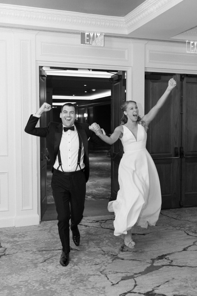 Black and white bride and groom entering reception at The Newbury Boston 