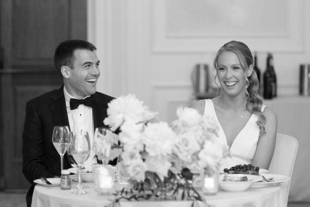 Black and white bride and groom faces during toasts