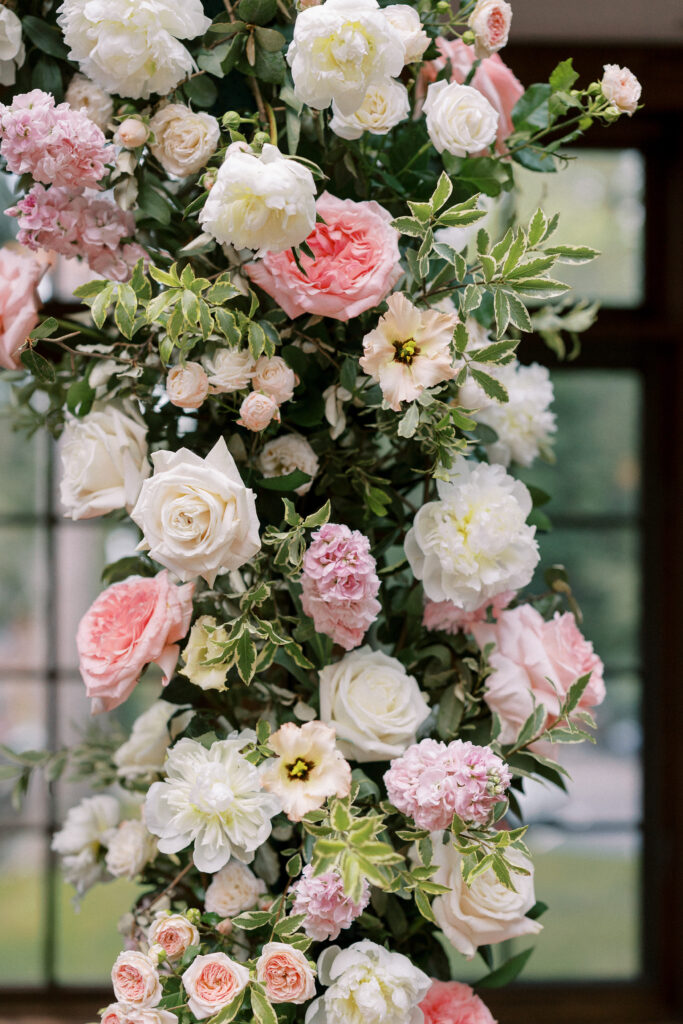 Close up of wedding arbor with pink and white flowers
