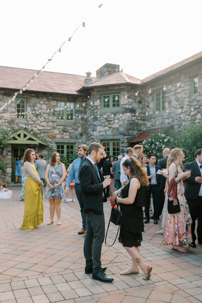 Outdoor cocktail hour in courtyard for summer wedding at Willowdale Estate