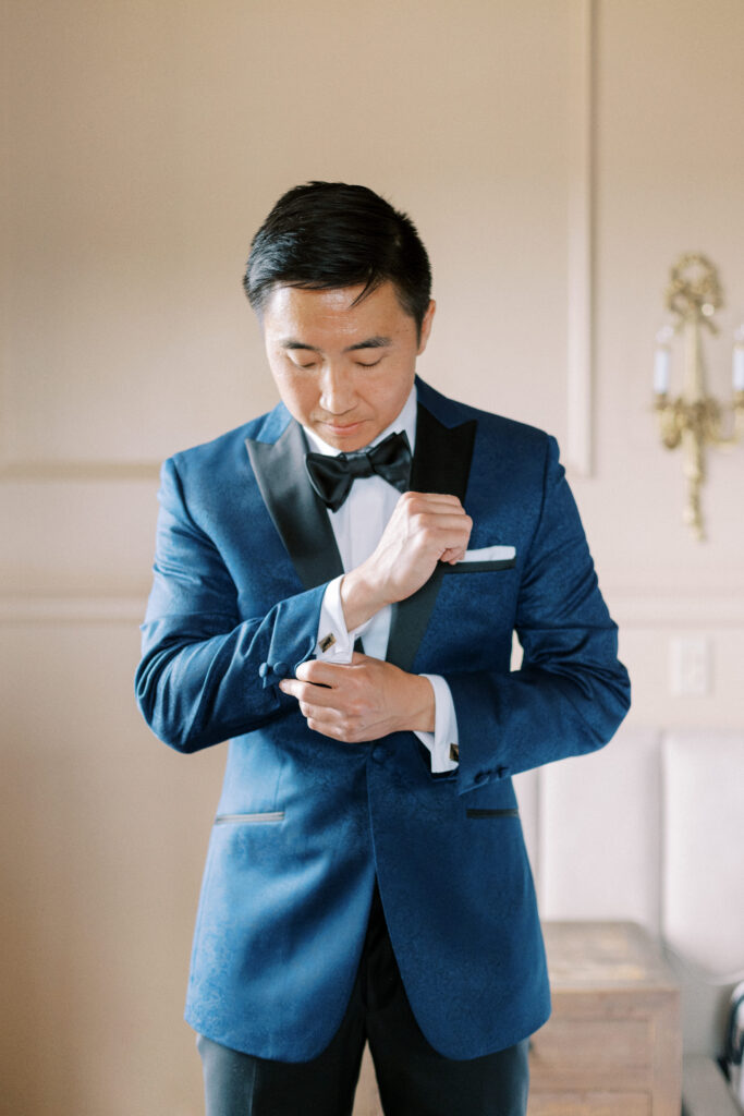 Groom getting ready in navy suit with black lapel for summer Willowdale Estate wedding