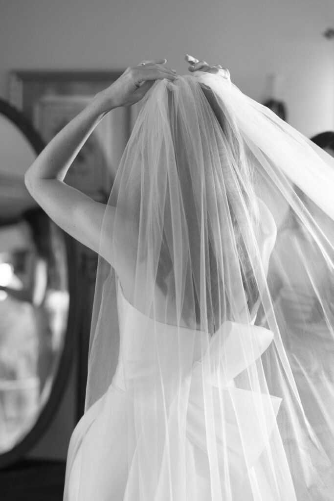 Bride putting on veil before Willowdale Estate wedding