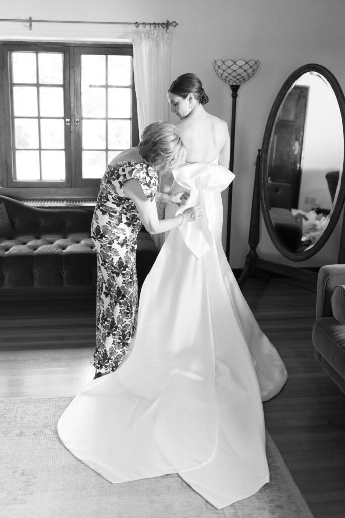 Bride getting into her gown for Boston North Shore wedding