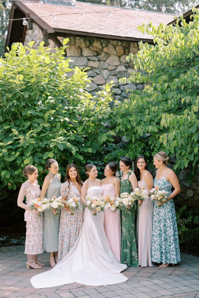 Bride and bridesmaids with mismatched floral dresses for summer wedding