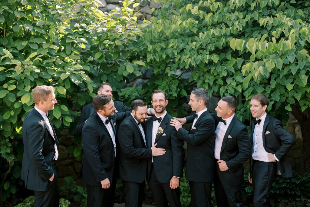 Groomsmen and groom candid wedding photo at Willowdale Estate