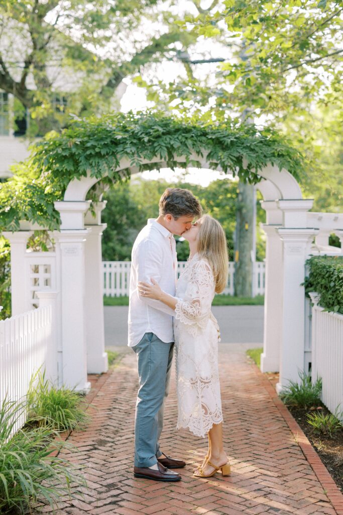 Couple kissing under an arbor in Edgartown 
