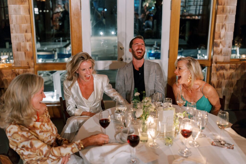 Candid photo of bride and groom laughing at rehearsal dinner on Martha's Vineyard 