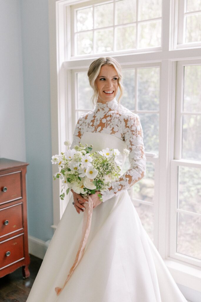 Bridal portrait while getting ready for Martha's Vineyard tented wedding wearing a long sleeve lace gown