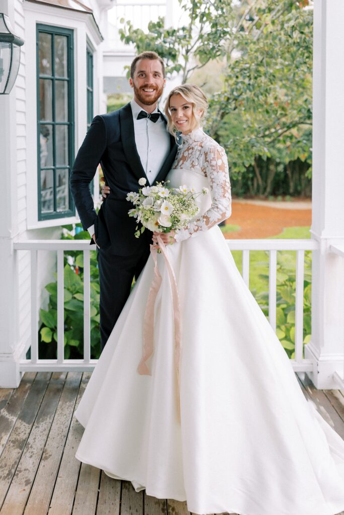 Bride and groom portrait during rainy first look on the porch of a Martha's Vineyard home
