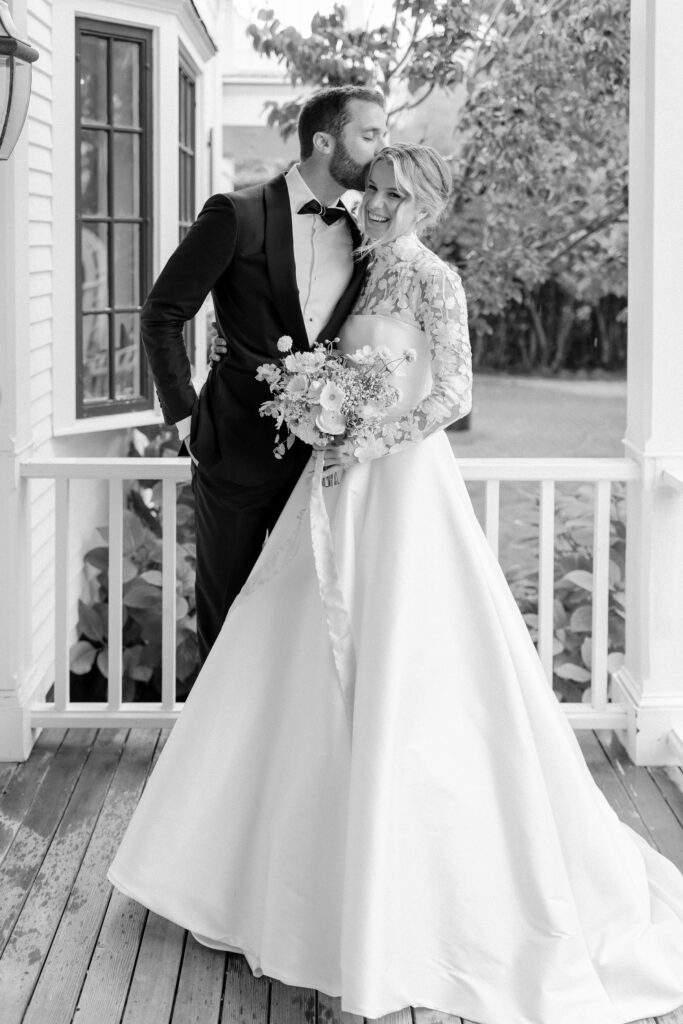 Bride and groom portrait during rainy first look on the porch of a Martha's Vineyard home