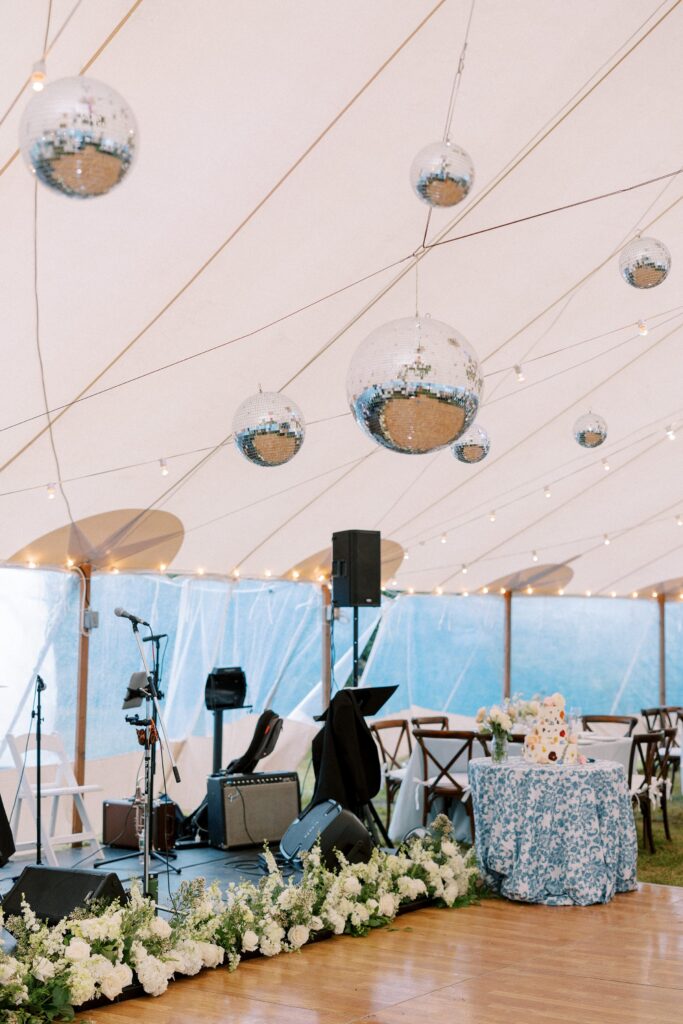 Tented reception with hanging disco balls over the dance floor