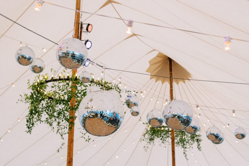 Hanging greenery and disco balls over the dance floor